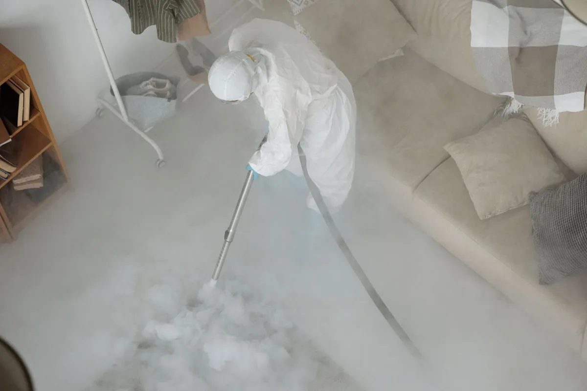 Biohazard cleanup technician in protective equipment, Fresno, CA